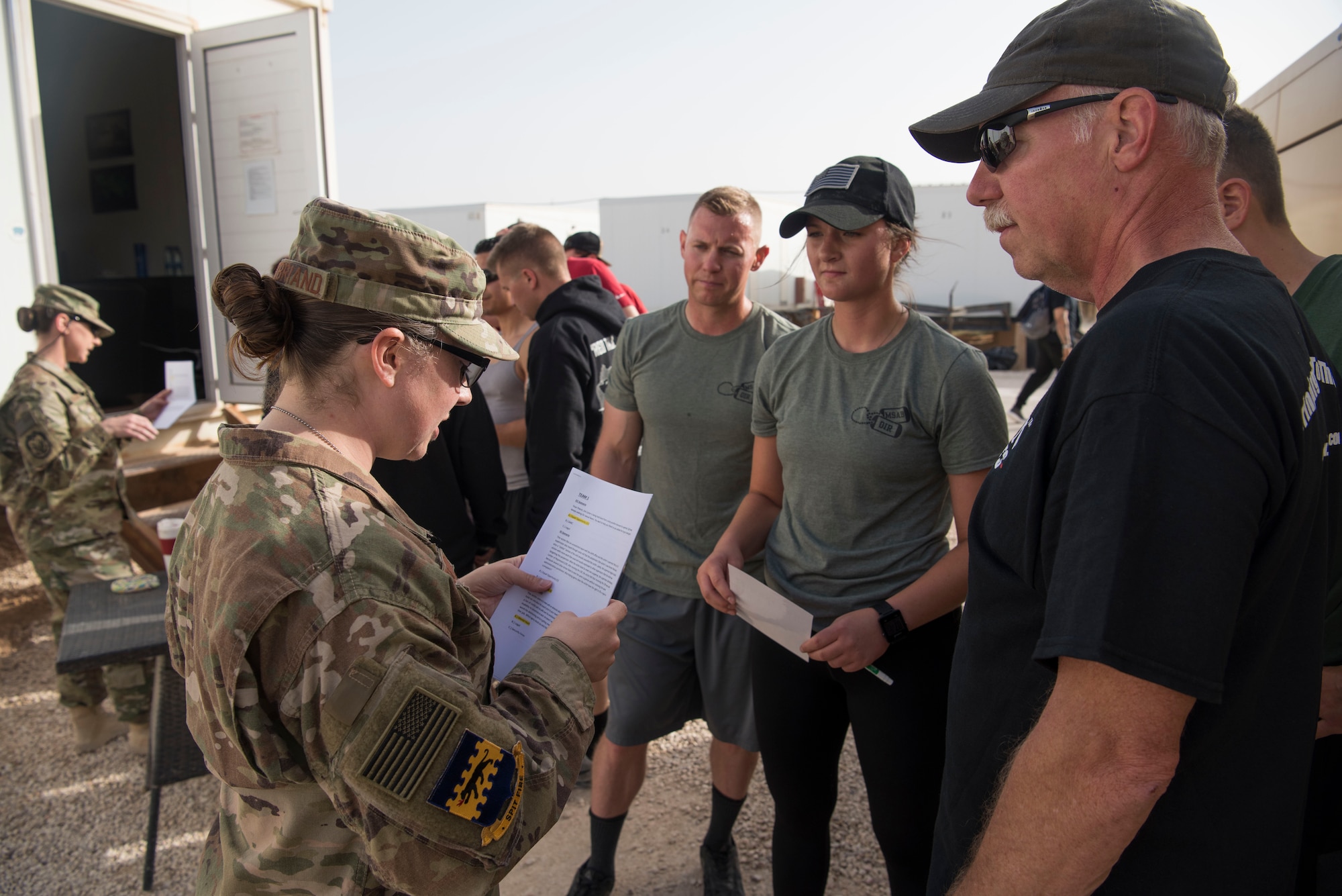 Master Sgt. Erin Pontbriand, 332nd Air Expeditionary Wing Equal Opportunity regional director, reads a scenario question to a team during the Commander’s Challenge at an undisclosed location in Southwest Asia May 4, 2018.