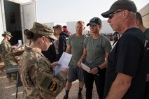 Master Sgt. Erin Pontbriand, 332nd Air Expeditionary Wing Equal Opportunity regional director, reads a scenario question to a team during the Commander’s Challenge at an undisclosed location in Southwest Asia May 4, 2018.