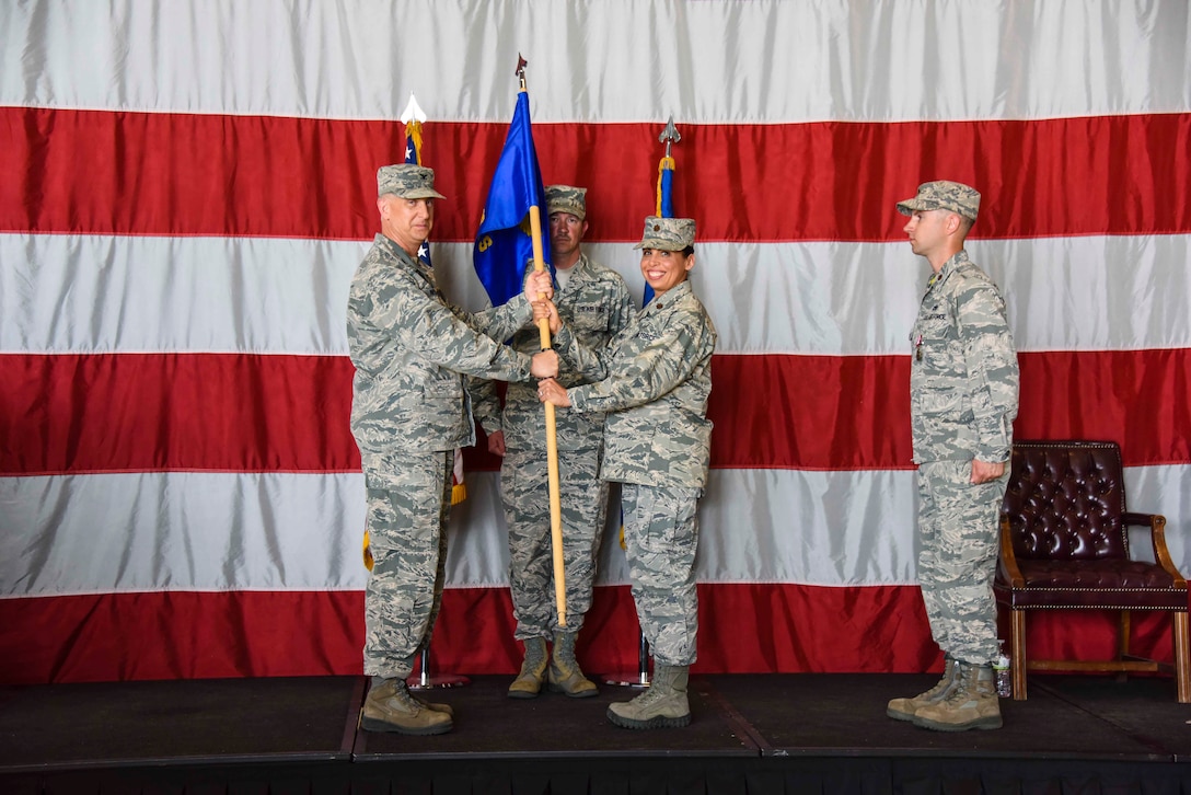 Maj. Kimberly Stevens, 419th Maintenance Squadron commander, accepts the squadron flag from Col. Brett Newman, 419th Maintenance Group commander, during a ceremony May 6, 2018, at Hill Air Force Base, Utah.