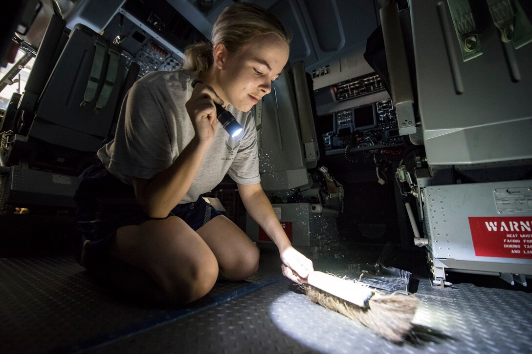 An Airman from the 71st Aircraft Maintenance Unit (AMU) uses a brush to sweep the cockpit of an HC-130J Combat King II, May 8, 2018, at Moody Air Force Base, Ga. Upon return from a deployment or every 180 days, HC-130’s are thoroughly cleaned and inspected as part of routine upkeep and to ensure its respective components are in working condition. (U.S. Air Force photo by Airman 1st Class Eugene Oliver)