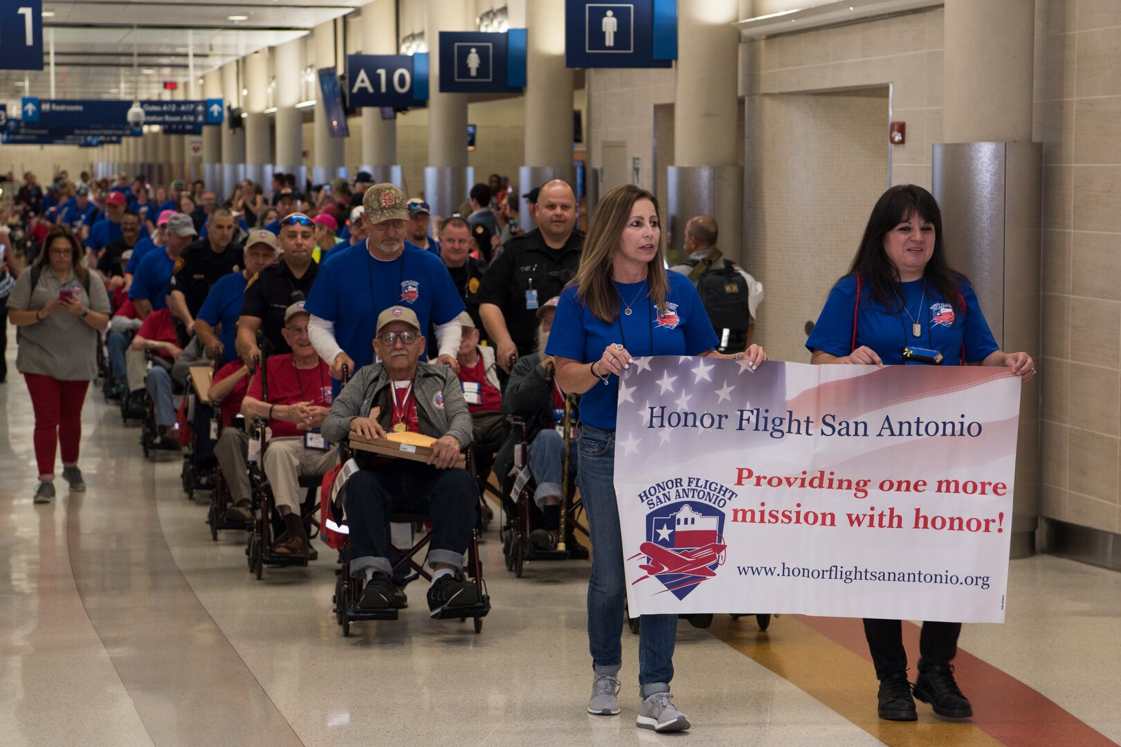 Volunteer "Guardians" for Honor Flight San Antonio parade around 40 veterans of the World War II, Vietnam War and Korean War at their welcome home celebration and ceremony May 5, 2018 at the San Antonio International Airport. Guardians for Honor Flight San Antonio make a $500 donation and are assigned to escort each veteran to ensure they have a "trip of a lifetime".