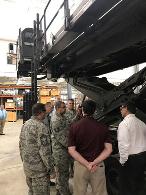 The Halvorsen 25K Loader is a rapidly-deployable, high-reach mechanized aircraft loader that can transport and lift up to 25,000 pounds of cargo and load it onto military aircraft. Tech. Sgt. Ryan Young, Halvorsen mechanic, answers questions from Concurrent Technologies Corporation engineers Kyle Reasbeck (left) and Bryan Tipton (right).