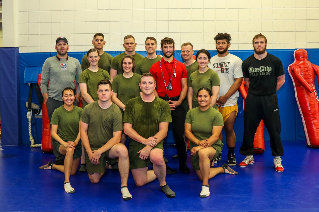 U.S. Marines with 8th Marine Corps District pose for a group photo with wrestlers during the district marketing and communications summit at the USA Wrestling Training Center in Colorado Springs, Colorado on May 8, 2018. The experience served to familiarize the RS MACs with the assets provided through the Marine Corps’ partnership with USA Wrestling, to include access to certain junior and cadet level events, and training camps for local wrestling clubs. (U.S. Marine Corps photo by Sgt. Clarence A. Leake)