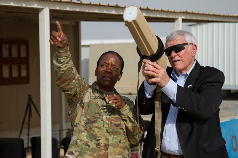 Chief Warrant Officer 3 Edna C. Lugo, command and control systems technician, Central Command, shows U.S. Representative John R. Carter, Texas, some counter unmanned aerial systems equipment and techniques, Camp Arifjan, Kuwait, May 4, 2018. U.S. Representatives John R. Carter and Roger Williams from Texas visited U.S. servicemembers in the middle east as part of a congressional delegation.
