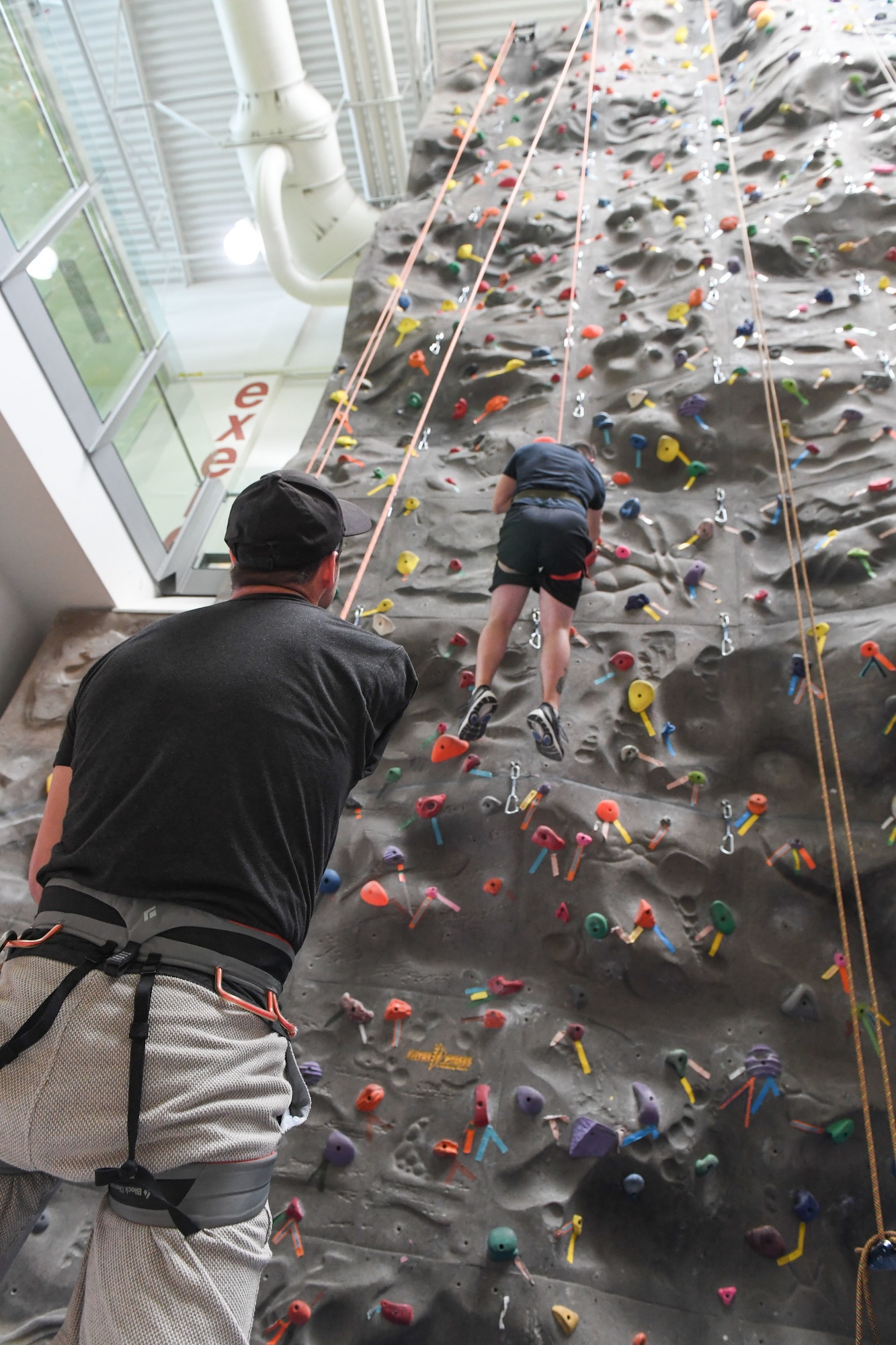 Victor Meier, 75th Force Support Squadron youth sports director, belays for David Forker, 573rd Aircraft Maintenance Squadron, at the Warrior Fitness Center April 25, 2018, at Hill Air Force Base, Utah. (U.S. Air Force photo by Cynthia Griggs)