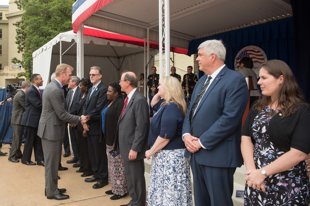 Deputy Defense Secretary Patrick M. Shanahan shakes hands with a line of award recipients.