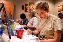 First Lt. Erin Westphal with the 50th Operations Support Squadron participates in an acrylic painting class during wingman Day at Schriever Air Force Base, Colorado May 4, 2018. Painting was one of 28 base-wide classes created to build a greater sense of community among Team Schriever members. (U.S. Air Force photo by Kathryn Calvert)