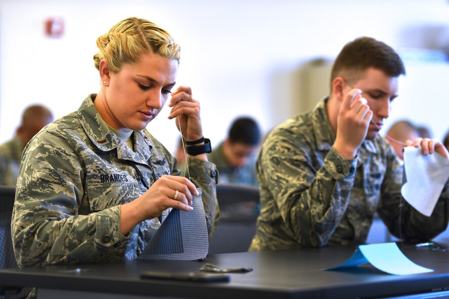 Second Lt. Kristina Brandes, 50th Operations Support Squadron, practices her newly learned sewing techniques in a sewing class during Schriever's biannual wingman day at Schriever Air Force Base, Colorado May 4, 2018.  Wingman Day is a multi-session event structured for members of the 50th Space Wing to enhance their resilience and sense of community.  (U.S. Air Force Photo by Dennis Rogers)
