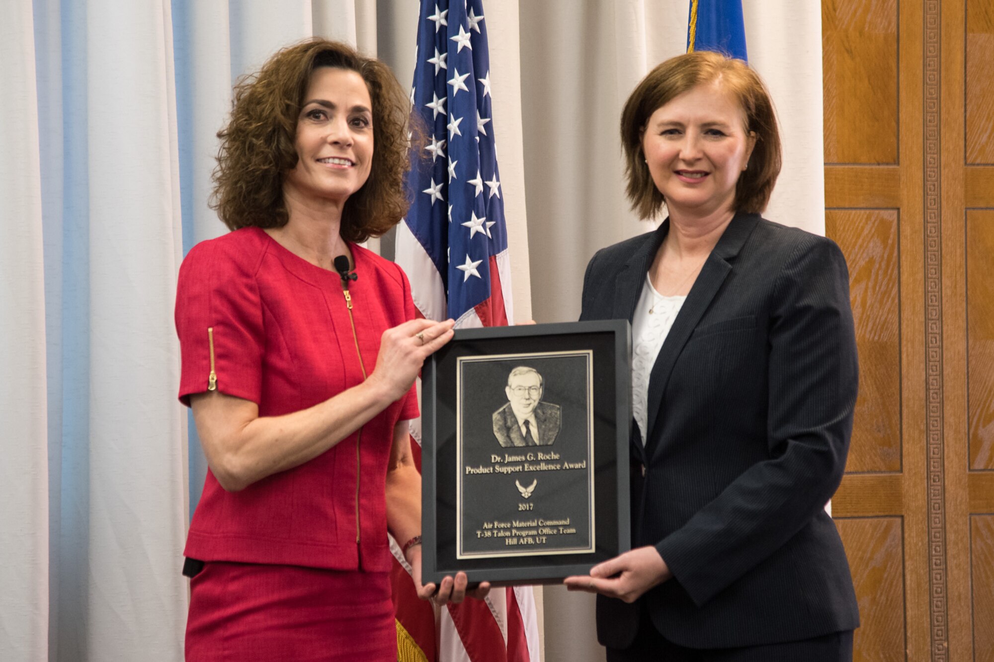 Lynda Rutledge (left), the Mobility and Training Aircraft Directorate Program Executive Officer, presented the 2017 Dr. James G. Roche Sustainment Excellence Award to Angela Micheal, T-38 Program Manager, May 8, 2018, at Hill Air Force Base, Utah. Micheal accepted the award on behalf of the Air Force Life Cycle Management Center T-38 Program Office. (U.S. Air Force photo)