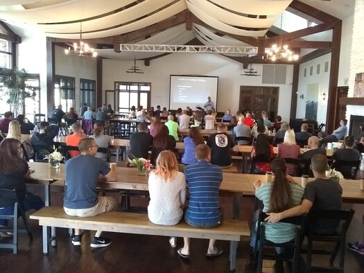 Military couples listen to a resiliency session on how to strengthen their marriages during an Air Expeditionary Force Family, or AEF, Retreat May 5, 2018. The base with support from the community routinely invites its military members deploying or just returning from a deployment to participate in a retreat along with their families to experience recreational opportunities, get to know one another better, and improve and build on resiliency. (Courtesy photo)