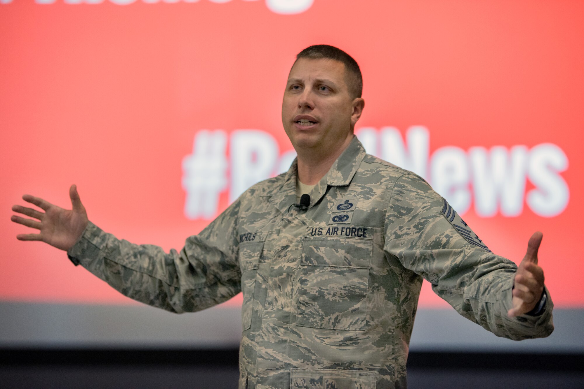 U.S. Air Force Chief Master Sgt. Steve Nichols, 60th Air Mobility Wing command chief, addresses members of the 60th AMW during a commander's call at Travis Air Force Base, Calif., May 8, 2018. Nichols is participating in his last commander’s calls as the command chief before retiring in September. (U.S. Air Force photo by Louis Briscese)