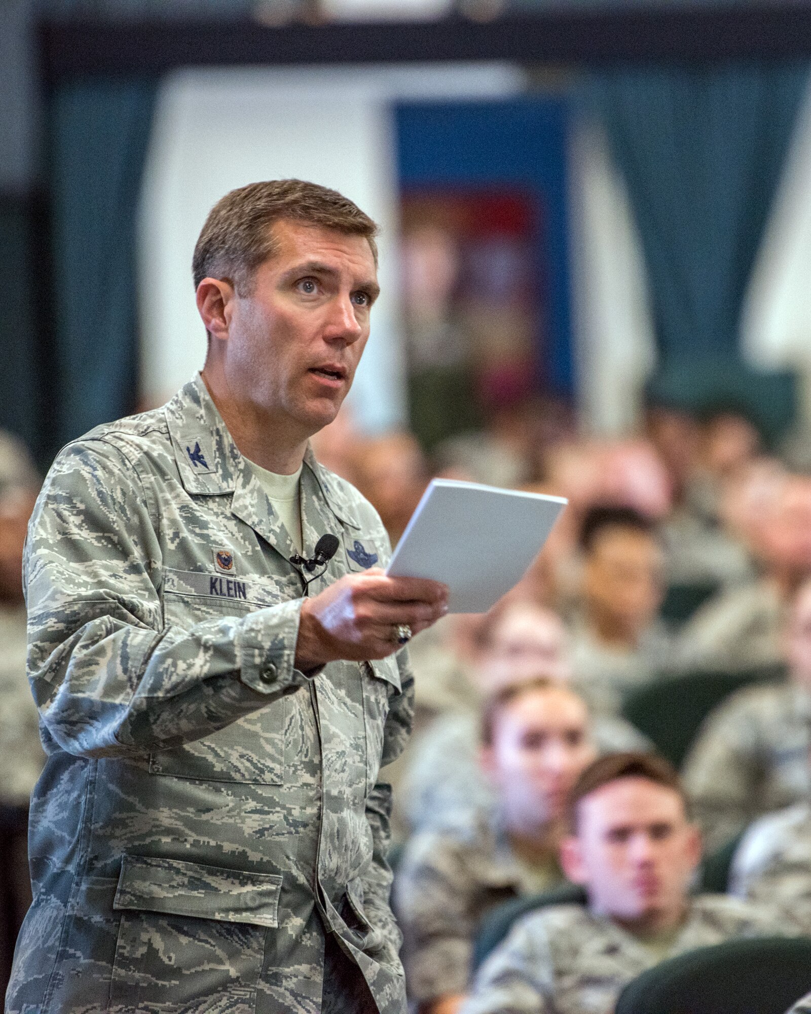 U.S. Air Force Col. John Klein, 60th Air Mobility Wing commander, addresses members of the 60th AMW during a commander's call at Travis Air Force Base, Calif., May 8, 2018. Klein is conducting his last commander’s calls as the commander of the 60th AMW before departing in July. (U.S. Air Force photo by Louis Briscese)