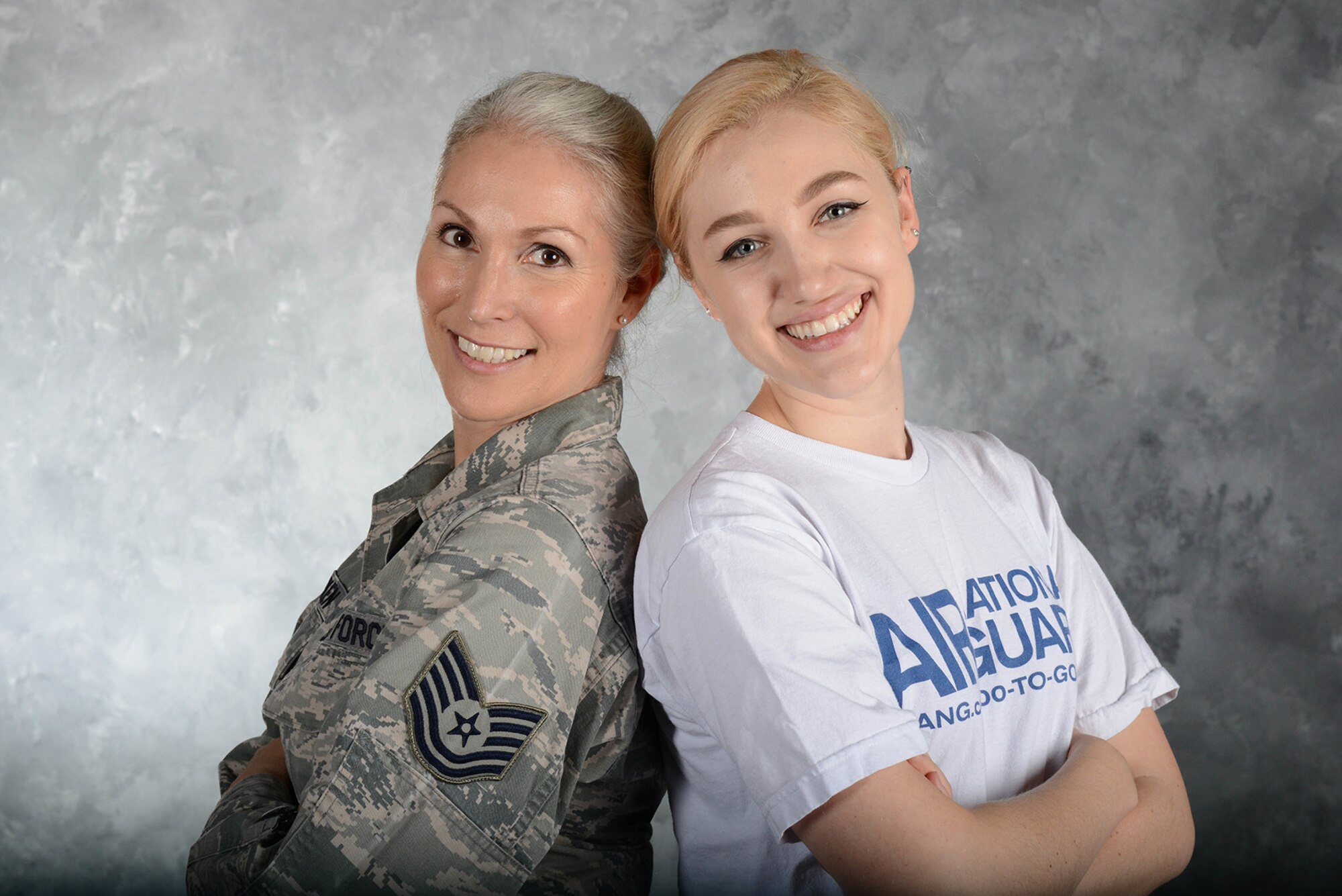Tech. Sgt. Lisa Menken, a contract specialist with the 136th Mission Support Group, Texas Air National Guard, poses with her daughter Charrisa Menken April 29, 2018 in the 136th Airlift Wing Public Affairs studio at Naval Air Station Fort Worth Joint Reserve Base, Texas.