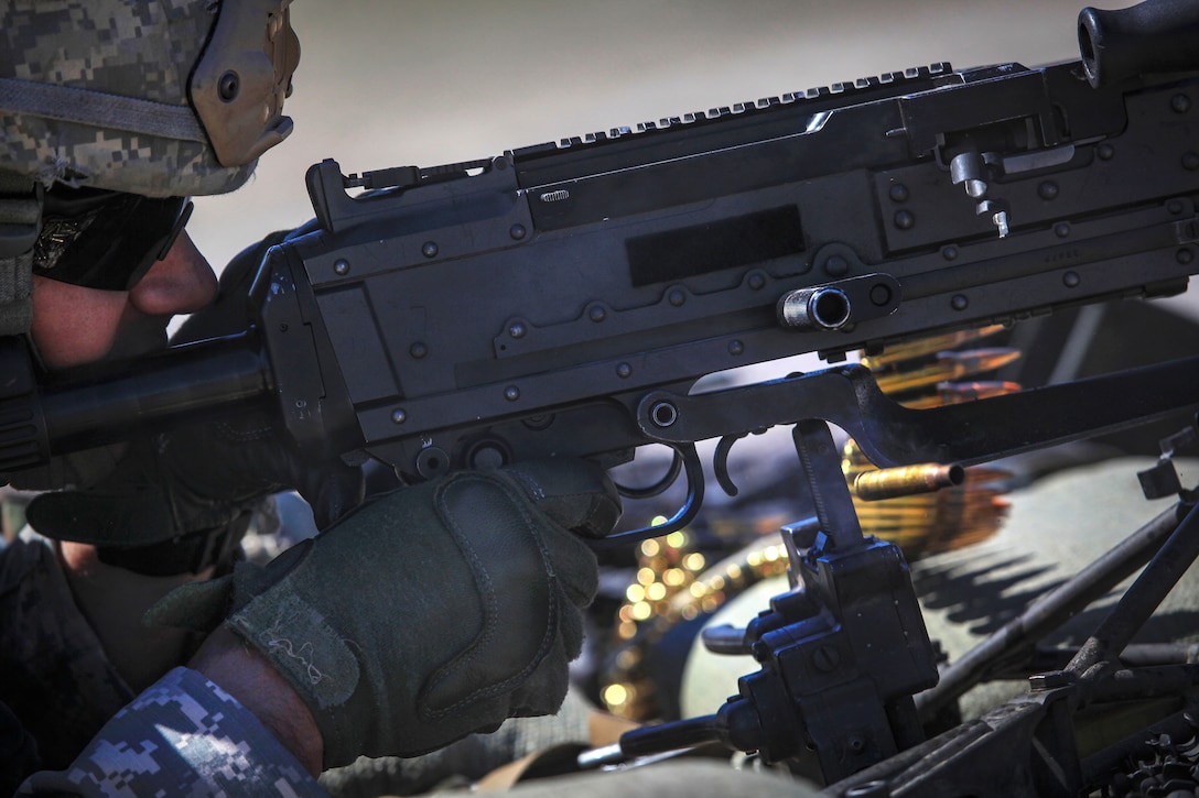 A soldier fires the M240B machine gun.