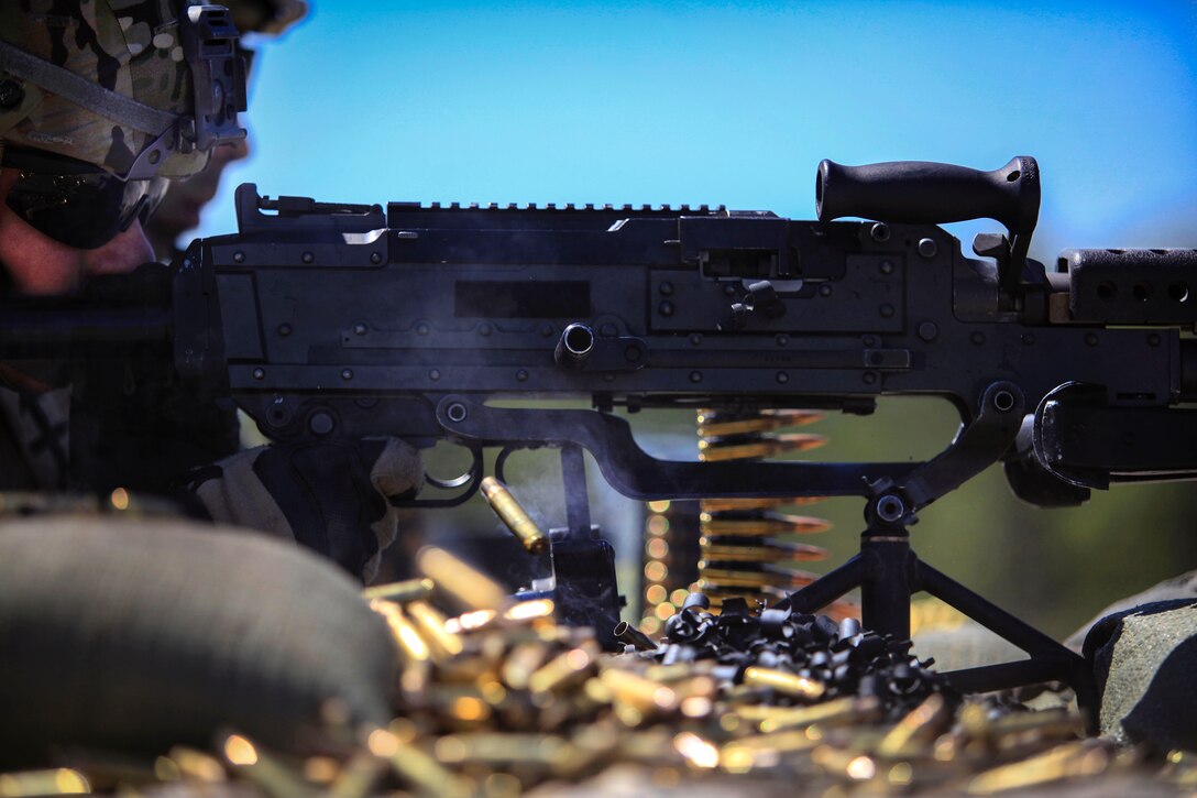 A soldier fires the M240B machine gun.