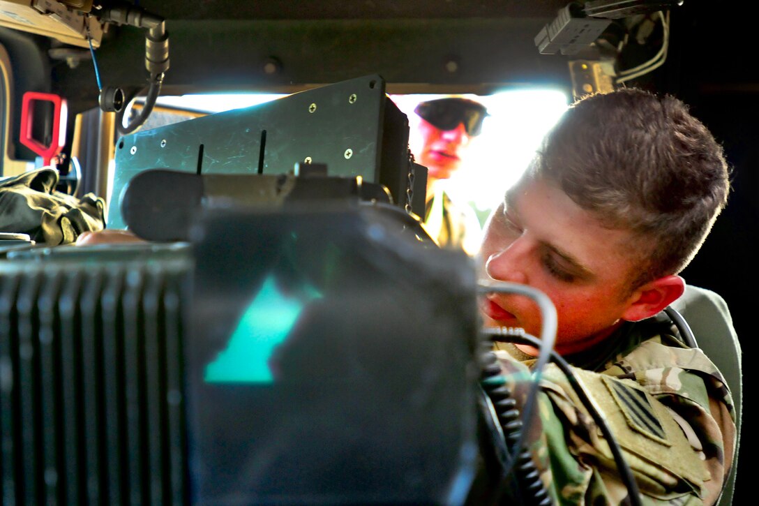 A soldier prepares a Humvee.