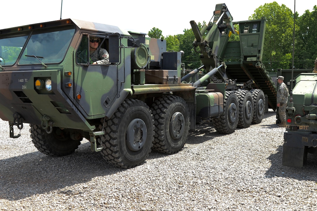 Soldiers load a pallet on an M1120 heavy expanded mobility tactical truck.