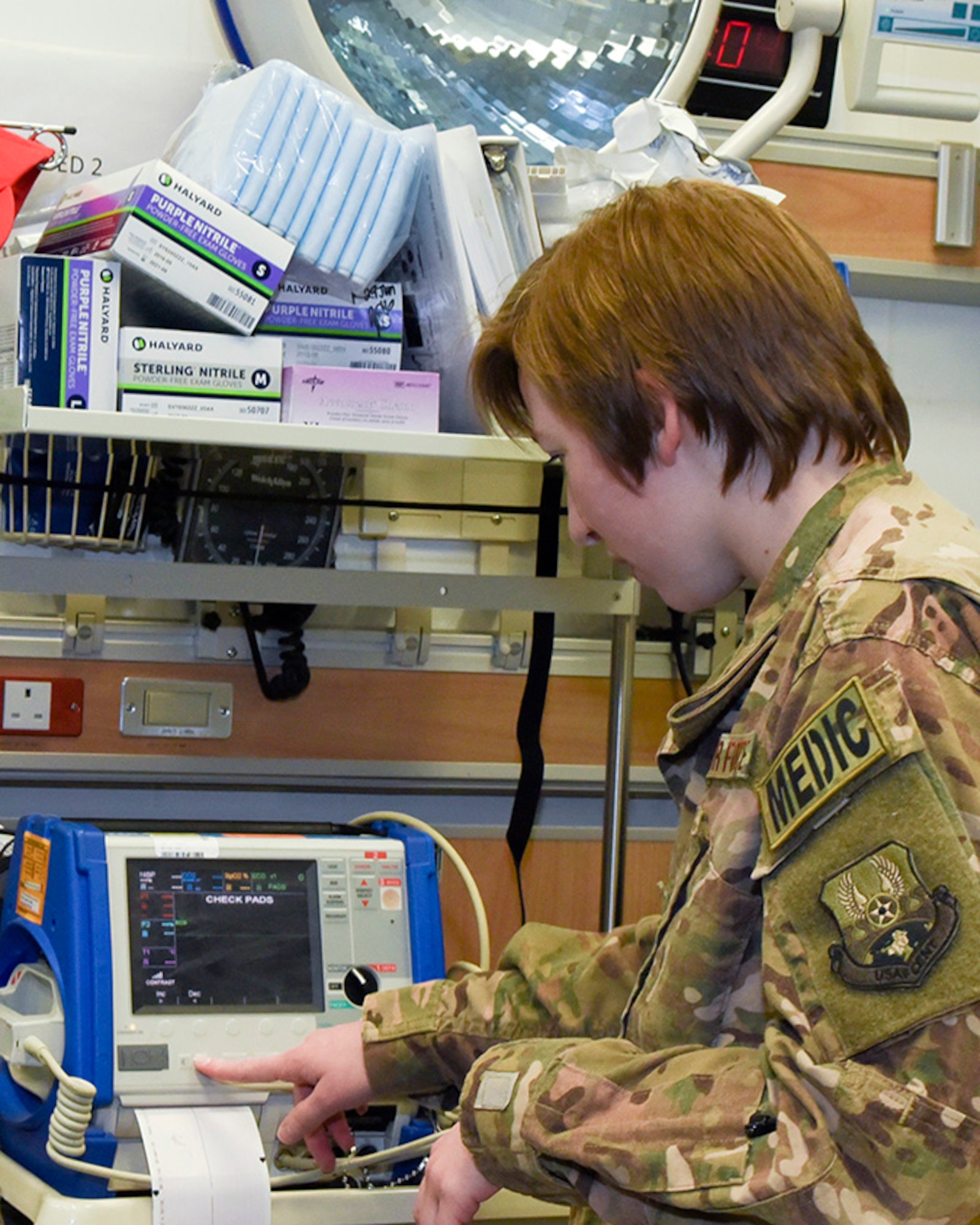 SrA Breanna Moore explains her role in the emergency room after the patient is transported out of the ambulance at Al Udeid Air Base, Qatar on May 5, 2018. Moore is assigned to the Expeditionary Medical Operations Squadron as an Aerospace Medical Technician, this is her second time deployed to Al Udeid in this capacity. (U.S. Air Force photo by Staff Sgt. Enjoli Saunders)