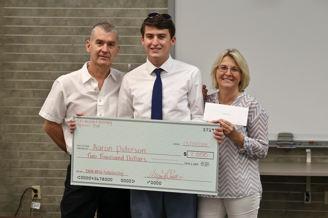 Aaron Peterson presents his scholarship award with his family during a ceremony aboard Marine Corps Air Station
Beaufort May 4. The Military Spouses Club awarded the scholarship based on achievement, character and merit.
Peterson was awarded a $2,000 scholarship to continue his educational pursuits.