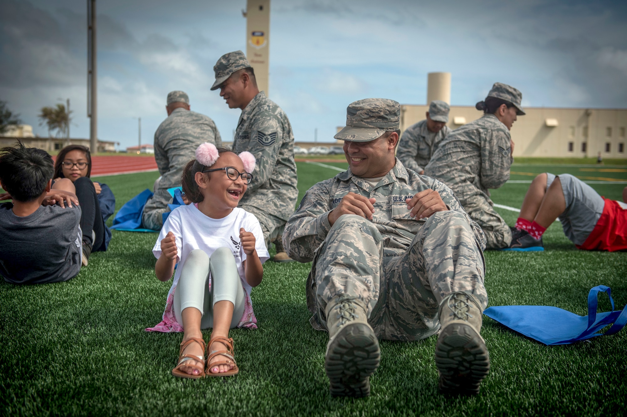 Air Force reservists assigned to the 44th Aerial Port Squadron, introduce military children to deployment processing procedures during Operation Inafa’ Maolek at Andersen Air Force Base, Guam, May 5, 2018. Military families shared a playful version of military processing to introduce children of deploying reservists to what their parents will experience when preparing for their deployment. The Chamorro term “Inafa' Maolek” literally translates into ‘to make’ (inafa’) ‘good’ (maolek). It describes the concept of restoring harmony or order. (U.S. Air Force photo by Staff Sgt. Alexander W. Riedel)