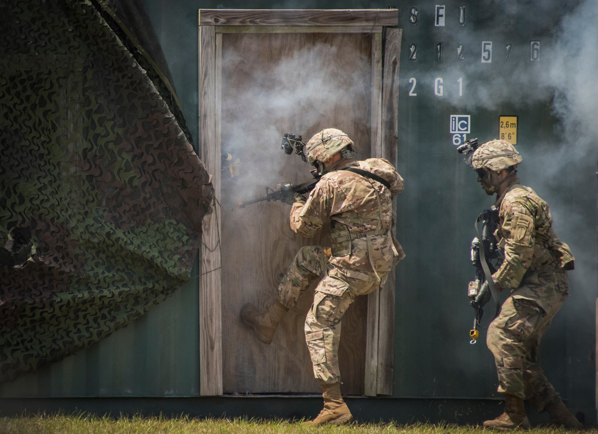 An Army Ranger kicks in a door during a demonstration at the 6th Ranger Training Battalion’s open house event May 5, 2018, at Eglin Air Force Base, Fla. The event was a chance for the public to learn how Rangers train and operate. The event displays showed equipment, weapons, a reptile zoo, face painting and weapon firing among others. The demonstrations showed off hand-to-hand combat, a parachute jump, snake show and Rangers in action. (U.S. Air Force photo by Samuel King Jr.)