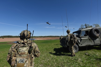 U.S. Air Force Tech Sgt. Laurence Paradis, Tactical Air Control Party member with Oklahoma National Guard’s 146th Air Support Operations Squadron, advises Estonian Defense Force on Joint Terminal Attack Controller capabilities May 9, 2018, during Exercise HEDGEHOG 2018 in Southern Estonia. The TACP personnel served as advisers to the Estonian Defense Force to create combined fires between U.S. Army and multinational aviation assets.