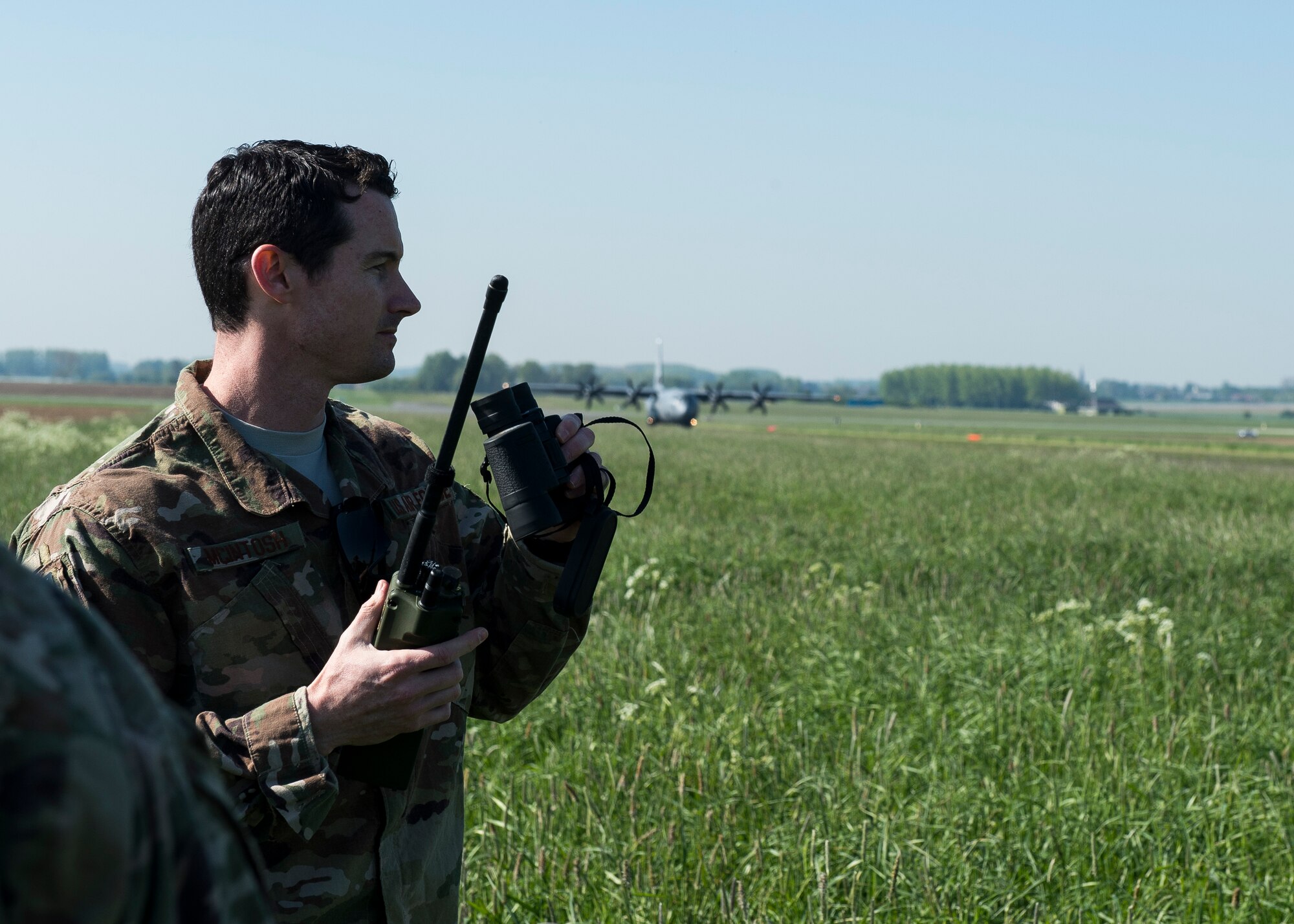 U.S. Air Force Lt. Col. Brady Vaira, 435th Contingency Response Group deputy commander, and Master Sgt. Benjamin Barnett, 435th Contingency Response Squadron Operations Flight superintendent, perform a communications check at Chievres Air Base, Belgium. Members of the 37th Airlift Squadron and 435th Contingency Response Group were testing and surveying the new landing zone’s integrity before opening it for future use. (U.S. Air Force photo by Staff Sgt. Jimmie D. Pike)