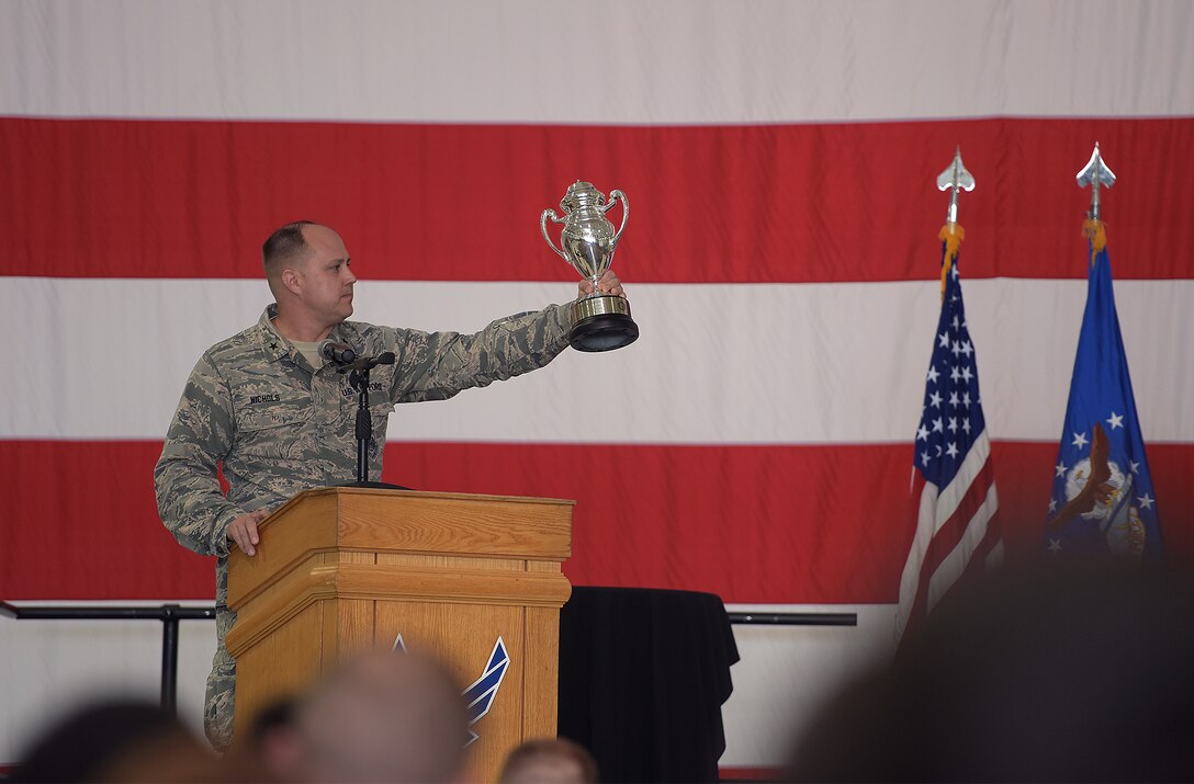 U.S. Air Force Brig. Gen. John Nichols, commander of the 509th Bomb Wing, holds up the Omaha Trophy during the award ceremony at Whiteman Air Force Base, Mo., May 8, 2018. The 509th and 131st Bomb Wings also earned the trophy in 2013 and the 509th received it in 2006. (U.S. Air Force photos by Airman 1st Class Taylor Phifer)
