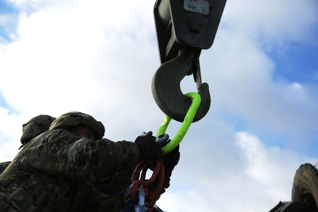 Danish soldiers of the Guard Hussar Regiment prepare a vehicle for recovery