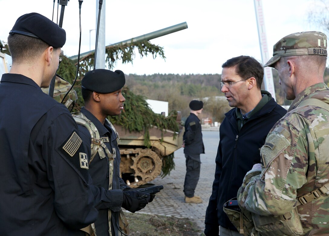 Mark T. Esper, Secretary of the Army, receives a demonstration by U.S. Army Sgt. Tevin Hampton,