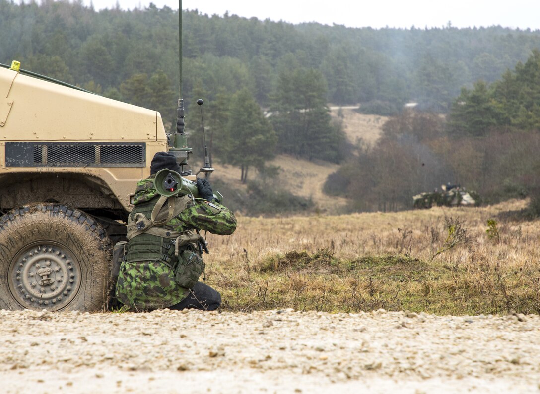 A Lithuanian National Defence Volunteer Forces (KASP) engages a simulated enemy armored vehicle with an anti-armor weapon