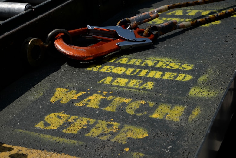 Harness straps lay near yellow caution paint attached to a Tunner 60K Aircraft Cargo Loader on Ramstein Air Base, Germany, May 9, 2018. The Tunner 60K Aircraft Cargo Loader was used as part of a demonstration to reemphasize the importance of fall protection for service members.  (U.S. Air Force photo by Airman 1st Class D. Blake Browning)
