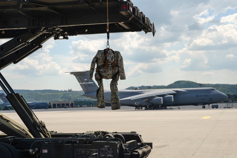 A dummy hangs from a Tunner 60K Aircraft Cargo Loader on the flight line during a demonstration for National Institute for Occupational Safety and Health officials May 9, 2018, on Ramstein Air Base, Germany. The demonstration held assisted NIOSH’s understanding the Air Force's mission, NIOSH official’s responsibilities are to conduct research to recommend rules and regulations to better protect personnel. (U.S. Air Force photo by Airman 1st Class D. Blake Browning)