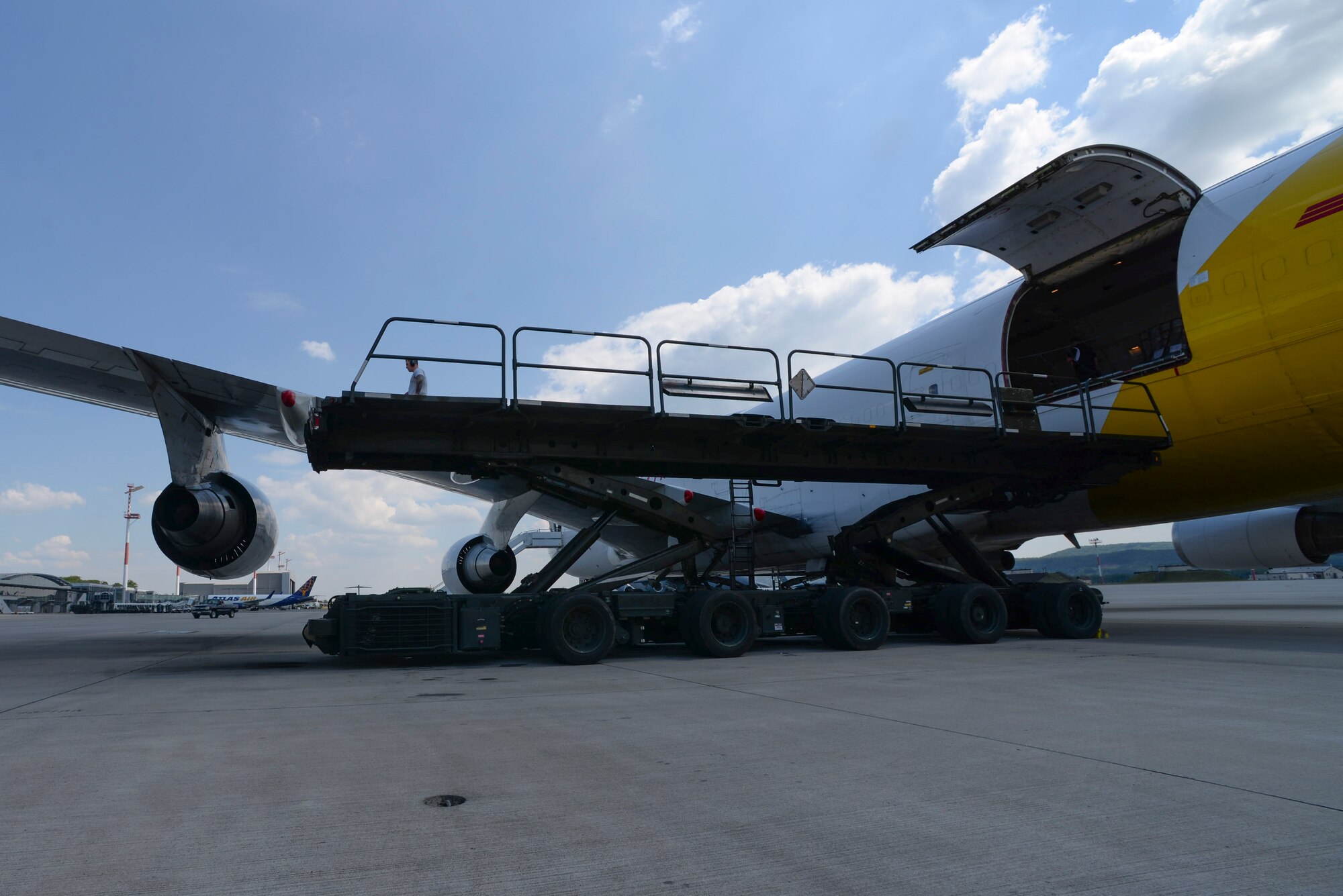 U.S. Airmen lower a Tunner 60K Aircraft Cargo Loader after loading an aircraft on Ramstein Air Base, Germany, May 9, 2018. A total of 318 Tunners have been added to the Air Force fleet since 1997 improving the capabilities and efficiencies to Air Force aerial ports worldwide. (U.S. Air Force photo by Airman 1st Class D. Blake Browning)