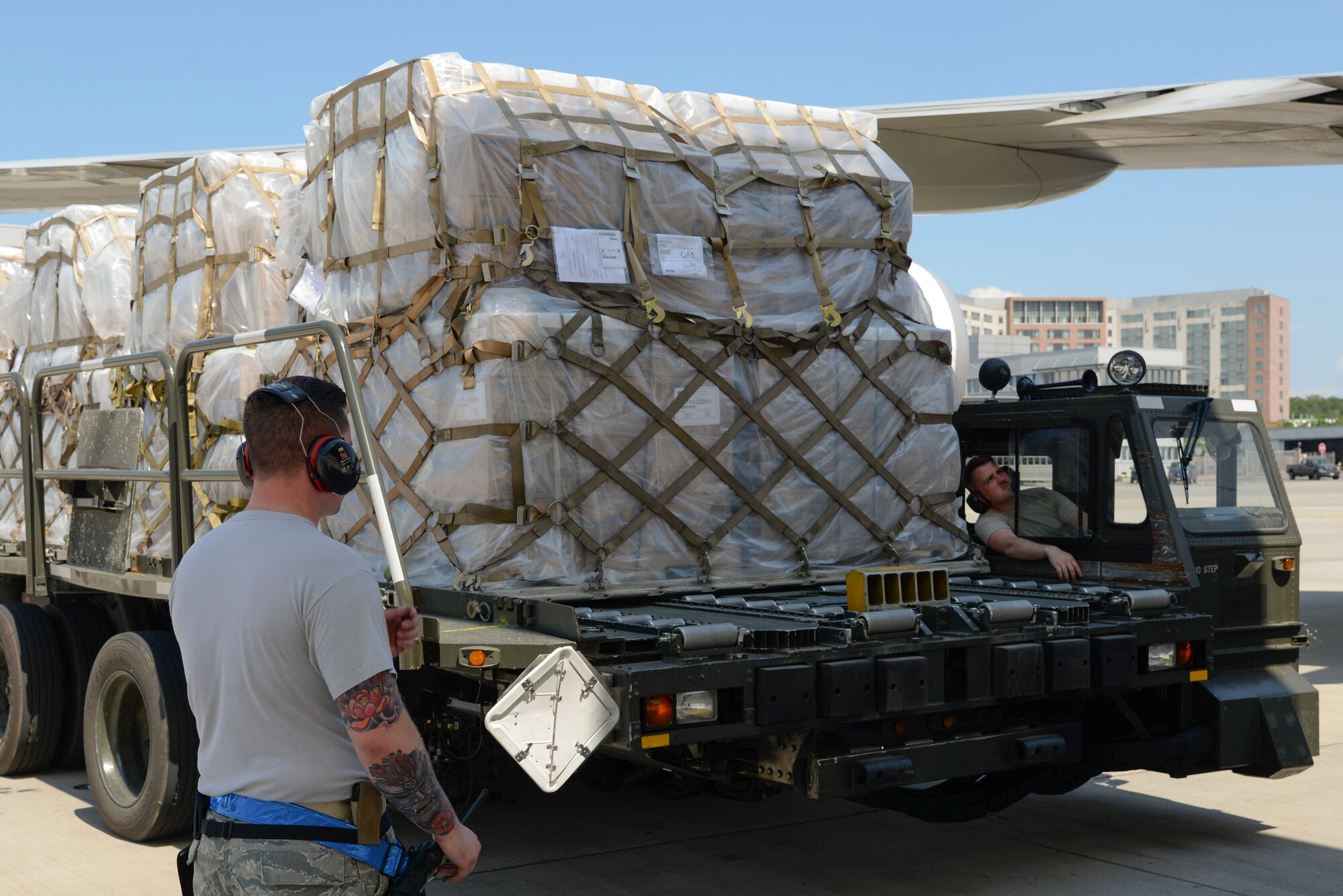 U.S. Airmen prepare to load an aircraft with a Tunner 60K Aircraft Cargo Loader on Ramstein Air Base, Germany, May 9, 2018. The Air Force controls a total of 318 Tunners which have improved the capabilities and efficiencies to Air Force aerial ports worldwide. (U.S. Air Force photo by Airman 1st Class D. Blake Browning)