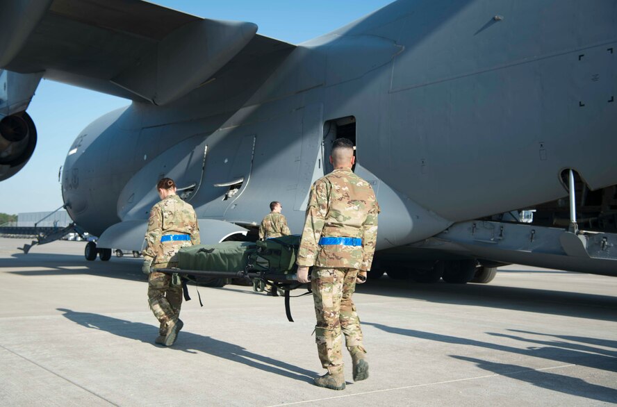 86th Aeromedical Evacuation Squadron Airmen load medical equipment on to a C-5 Galaxy aircraft during a burn victim evacuation exercise on Ramstein Air Base, Germany, May 9, 2018. The 86th AES and Critical Air Transport Team transformed the C-5 into a flying hospital with equipment such as fluids, oxygen machines, and stanchion litter systems. (U.S. Air Force photo by Senior Airman Elizabeth Baker)