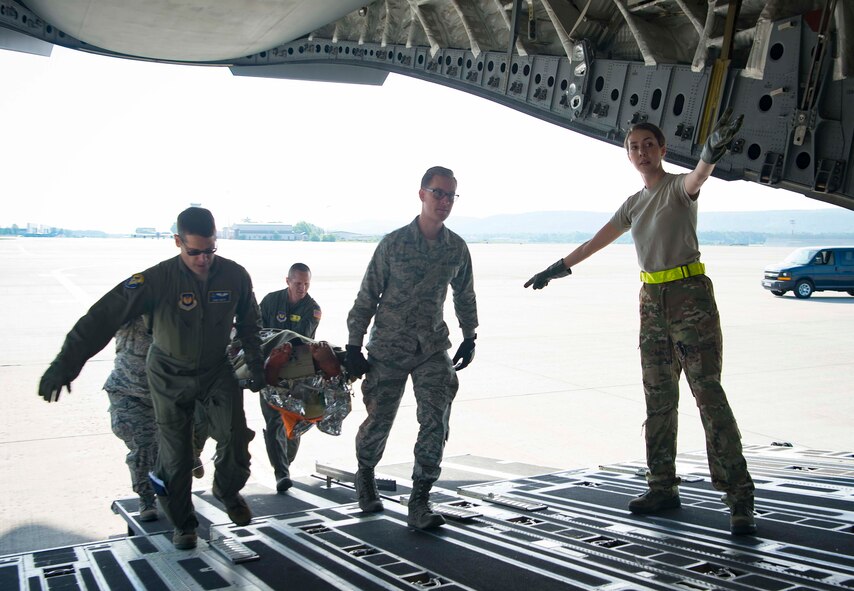 86th Medical Squadron Critical Care Air Transport Team Airman move a simulated burn victim onto a C-5 Galaxy during a burn victim evacuation exercise on Ramstein Air Base, Germany, May 9, 2018. The 86th Medical Squadron is a high-paced squadron that trains constantly and is ready to respond any moment, day or night, to save lives across Europe and Africa. (U.S. Air Force photo by Senior Airman Elizabeth Baker)
