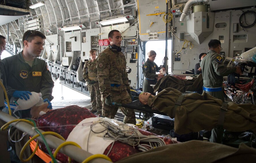 86th Aeromedical Evacuation Squadron Airmen carry a simulated patient onto a C-5 Galaxy during a burn victim evacuation exercise on Ramstein Air Base, Germany, May 9, 2018. To add to the realism of training, the 86th Medical Squadron uses high-tech mannequins that can mimic human conditions with features such as a simulated pulse, lungs, and heart rate. (U.S. Air Force photo by Senior Airman Elizabeth Baker)