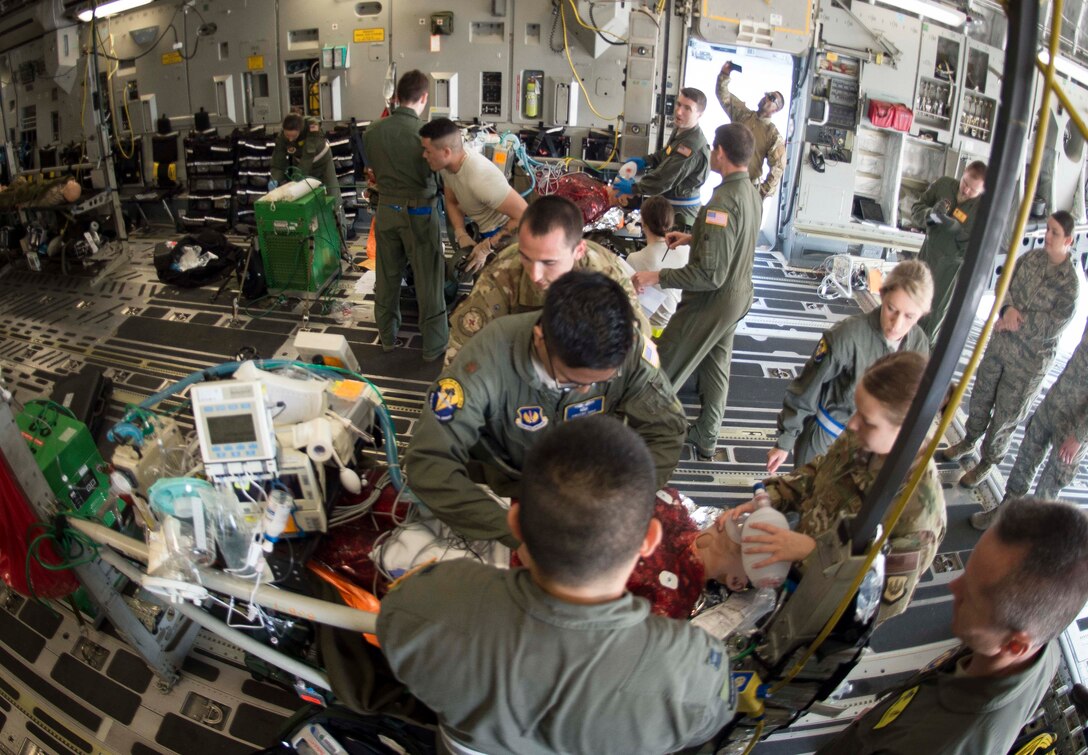 86th Aeromedical Evacuation Squadron and Critical Care Air Transport Team Airmen transform a C-5 Galaxy into a flying hospital during a burn victim evacuation exercise on Ramstein Air Base, Germany, May 9, 2018. The teams set up equipment on the aircraft, such as fluids, oxygen machines, and stanchion litter systems, to provide full simulated care for patients just as they would in a real scenario. (U.S. Air Force photo by Senior Airman Elizabeth Baker)