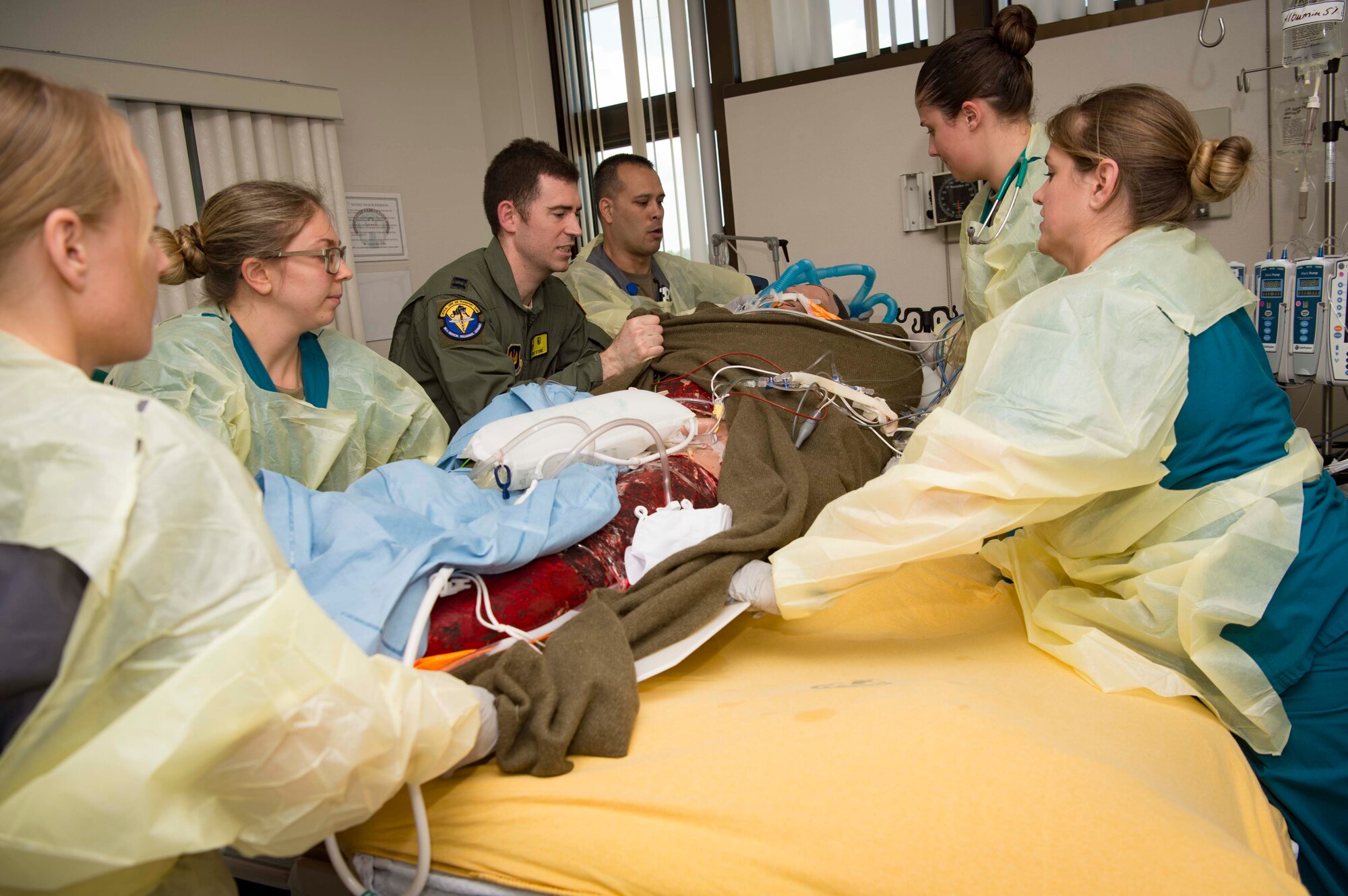 86th Medical Squadron nurse technicians and a Critical Care Air Transport Team Airman shift a simulated burn victim from a gurney to a hospital bed during a burn victim evacuation exercise on Landstuhl Regional Medical Center, Germany, May 9, 2018. The 86th MDS Critical Care Air Transport Team, Aeromedical Evacuation Squadron, and En-Route Patient Staging Flight worked together to transport two mannequins onto an aircraft, and from the aircraft to LRMC, just as they would in a real-world scenario. (U.S. Air Force photo by Senior Airman Elizabeth Baker)