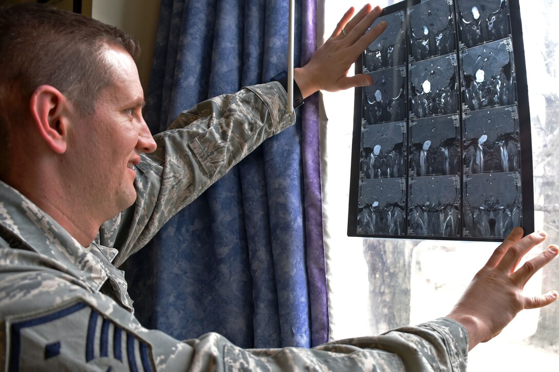 Air Force Master Sgt. Geoffrey VanDyck, the 707th Force Support Squadron’s first sergeant, views an image of the tumor found on his auditory nerve, at Fort Meade, Md.