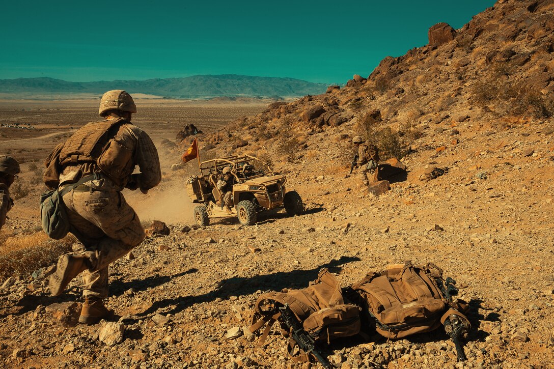 Marines with 3rd Battalion, 4th Marines, 7th Marine Regiment, 1st Marine Division, run to get ammunition for their fellow Marines at Range 400 during Integrated Training Exercise 3-18 aboard the Marine Corps Air Ground Combat Center, Twentynine Palms, Calif., May 7, 2018. The purpose of ITX is to create a challenging, realistic training environment that produces combat-ready forces capable of operating as an integrated Marine Air Ground Task Force. (U.S. Marine Corps photo by Lance Cpl. Isaac Cantrell)