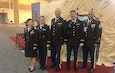 Five medical Soldiers standing front of a medical tent display