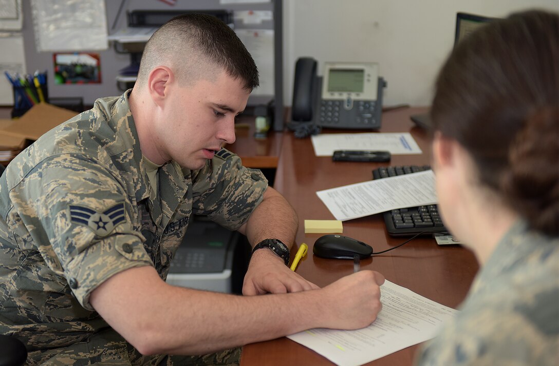 U.S. Air Force Senior Airman Matthew Helmich, a finance technician assigned to the 509th Comptroller Squadron, in-processes Lt. Col. Rachel Freestrom, the 509th Communications Squadron incoming commander, at the Whiteman Welcome Center at Whiteman Air Force Base, Mo., May 7, 2018. The center, which is part of the Task Force True North resiliency program, acts as the one-stop shop for in-processing newcomers to the base. Active duty members and government civilian employees are being surveyed through May 18 about behavioral health within their units and families in an effort to enhance resources available to them. (U.S. Air Force photo by Airman 1st Class Taylor Phifer)