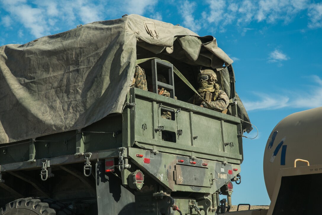 Marines with 1st Battalion, 3rd Marine Regiment, 3rd Marine Division, arrive in the back of a 7-ton to assault Range 111 during Integrated Training Exercise 3-18 aboard the Marine Corps Air Ground Combat Center, Twentynine Palms, Calif., May 9, 2018. The purpose of ITX is to create a challenging, realistic training environment that produces combat-ready forces capable of operating as an integrated Marine Air Ground Task Force. (U.S. Marine Corps photo by Lance Cpl. Isaac Cantrell)