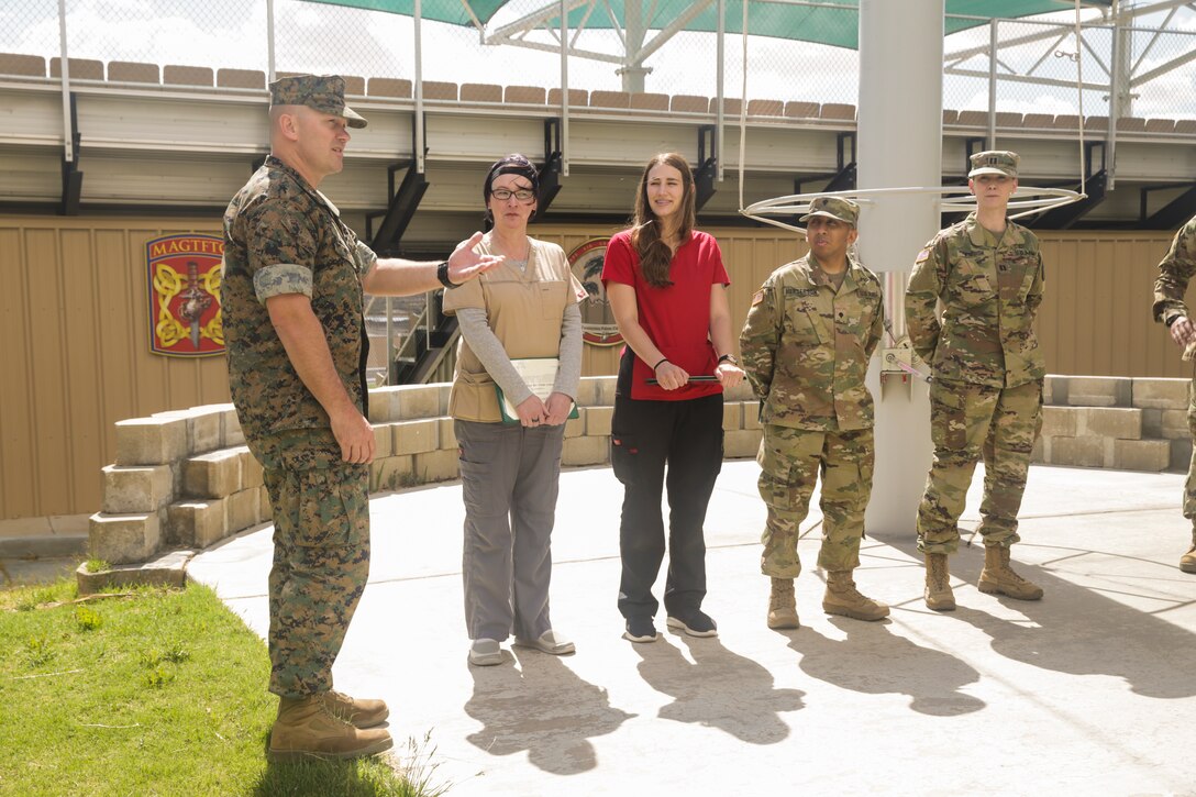 Col. Jay Wiley, assistant chief of staff, Installation Support Directorate, speaks about the soldiers and civilians with the Army's Mojave Branch Veterinary Services, U.S. Army Public Health who received the Army Commedation Medal and the Army's Achievment Medal for Civilian Service at the flag pole aboard the Marine Corps Air Ground Combat Center, Twentynine Palms, Calif., May 2, 2018. The soldiers and civilians received the medals for assisting and stabilizing a motorcyclist involved in a car accident in the local community. (U.S. Marine Corps photo by Lance Cpl. Dave Flores)