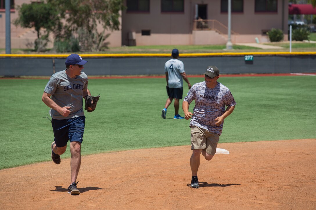 A Marine with Marine Corps Air Station Miramar’s softball team and a San Diego Padres Alumnus run to homeplate during a game between the Padres and MCAS Miramar softball team at MCAS Miramar, Calif., May 10. The Padres Alumni came to demonstrate their support for the military with spirited competition and to thank the service members of MCAS Miramar for their service. (U.S. Marine Corps photo by Cpl. Daniel Auvert/Released)