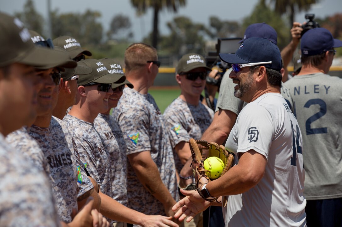 Marines with Marine Corps Air Station Miramar’s softball team and San Diego Padres Alumni shake hands prior to playing a softball game on MCAS Miramar, Calif., May 10. The Padres Alumni came to demonstrate their support for the military with spirited competition and to thank service members of MCAS Miramar for their service. (U.S. Marine Corps photo by Cpl. Daniel Auvert/Released)