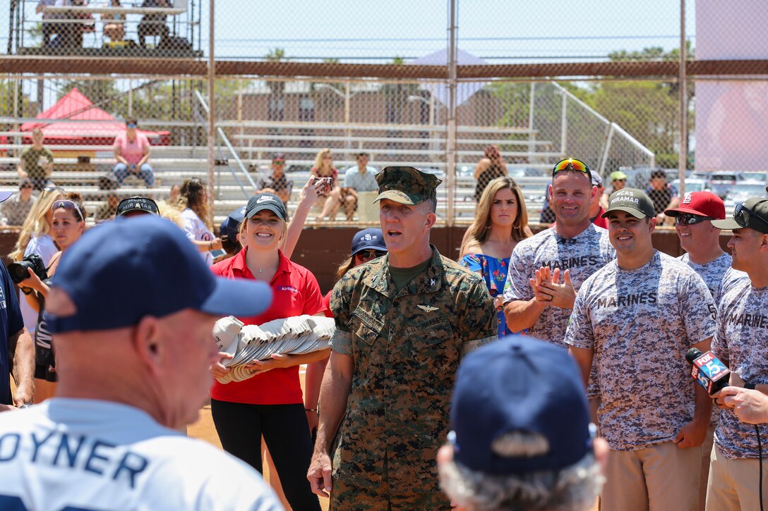 Col. Jason G. Woodworth, commanding officer of Marine Corps Air Station Miramar, speaks to the Marines of MCAS Miramar and the San Diego Padres Alumni prior to their softball game at MCAS Miramar, Calif., May 10. The Padres Alumni came to demonstrate their support for the military with spirited competition and to thank service members of MCAS Miramar for their service. (U.S. Marine Corps photo by Cpl. Daniel Auvert/Released)
