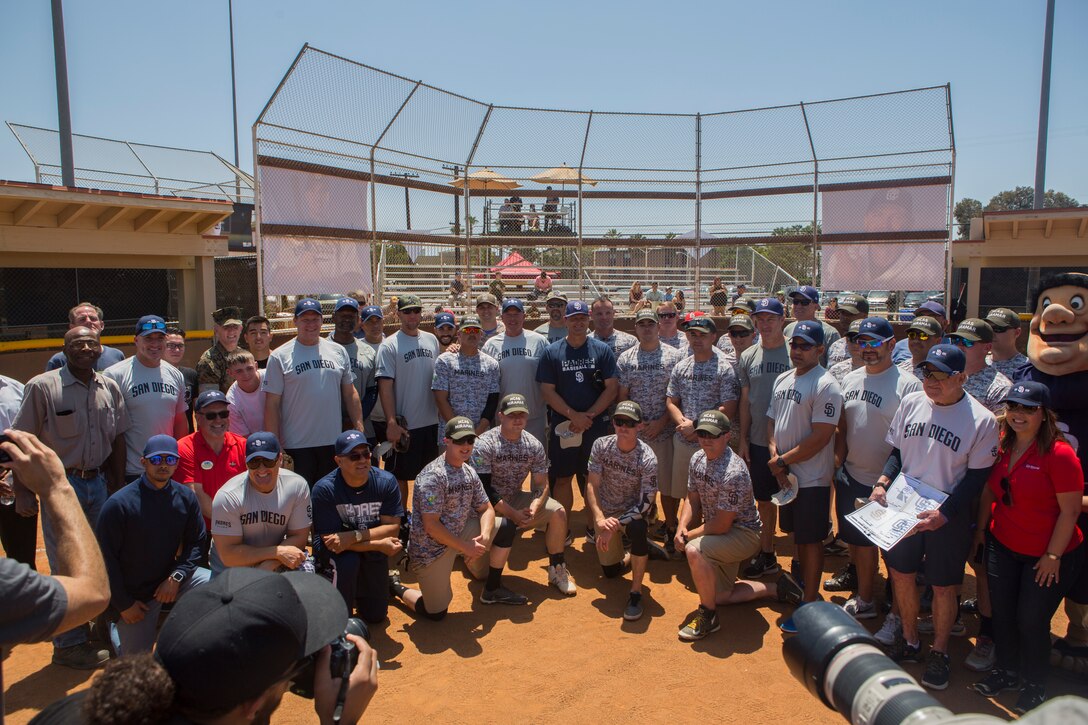 Marines with Marine Corps Air Station Miramar’s softball team and San Diego Padres Alumni pose for group photo prior to their softball game at MCAS Miramar, Calif., May 10. The Padres Alumni came to demonstrate their support for the military with spirited competition and to thank service members of MCAS Miramar for their service. (U.S. Marine Corps photo by Cpl. Daniel Auvert/Released)
